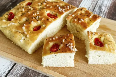 Oryginalna włoska focaccia przepis: puszyste ciasto z pomidorkami i solą morską, idealne na przekąskę.