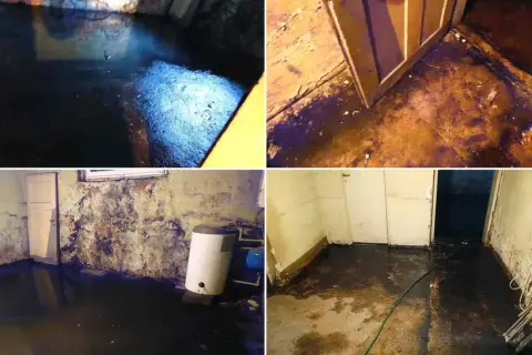 Woda w piwnicy zalewa podłogę i ściany. Widać bojler i drzwi.