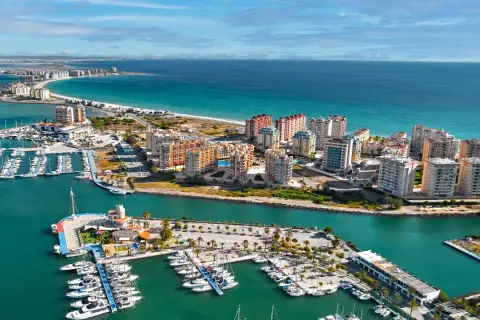 Widok na La Manga, Hiszpania: luksusowe apartamenty i pełen jachtów port nad turkusowym morzem.