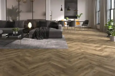 Drewniana podłoga w jodełkę w odcieniu wenge, tworząca ciepłą atmosferę w nowoczesnym salonie z szarą sofą i jadalnią.
