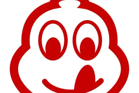 Uśmiechnięta postać z czerwonym logo Michelin, symbolizująca doskonałe jedzenie, które zasługuje na wyróżnienie bib gourmand.