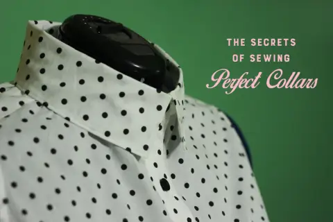 A white polka dot shirt with a crisp collared neckline, ready for sewing perfection.