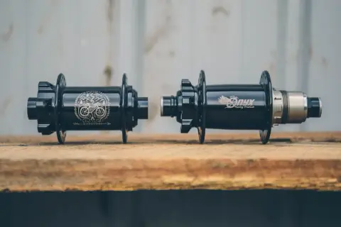 Two black Onyx Vesper hubs, one with a skull and bike graphic, the other with the Onyx logo, ready for a review.