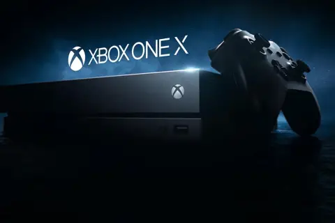 Konsola Xbox One X i kontroler na ciemnym tle. Gotowi na epicką rozgrywkę?