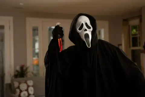 Postać w masce Ghostface z filmu "Krzyk" trzyma nóż.