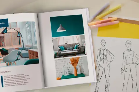 Otwarta księga prezentuje portfolio zawodowe z projektami wnętrz i szkicami mody.