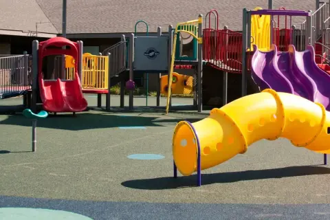 Bunter Spielplatz in Burscheid indoor mit Rutschen, Tunnel und Klettergerüst.