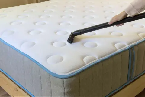 Vacuuming mattresses to remove dust mites and allergens.