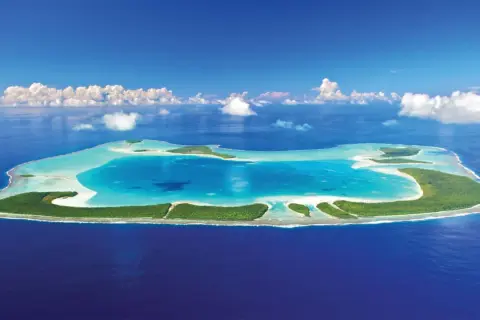 En grönskande atoll med turkost vatten, en dröm om Franska Polynesien.