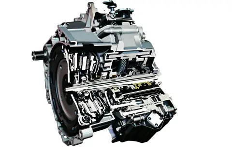 Przekrój nowoczesnej sekwencyjnej skrzyni biegów z widocznymi elementami mechanicznymi i hydraulicznymi.