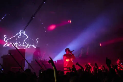 Raper na scenie w otoczeniu tłumu i neonowego logo Red Bulla. Już wkrótce kolejne emocjonujące koncerty Warszawa 2026!