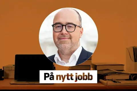 Fredrik Rosengren med glasögon, redo för ett nytt jobb. En laptop och böcker på skrivbordet.