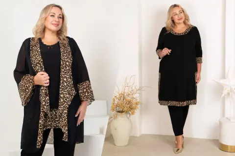 Kobieta w eleganckiej odzieży plus size z panterkowym wzorem. Czarna tunika i narzutka podkreślają styl.