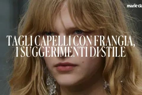 Close-up of a woman with blonde hair and bangs, with text overlay.