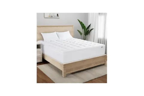 A Serta mattress topper on a bed. Wondering how long does a Serta mattress take to expand? This topper is ready for sleep.