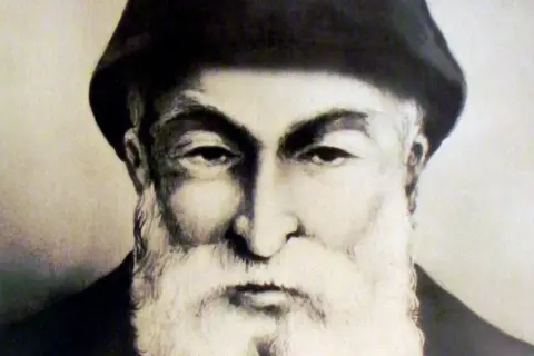 Portret ojca Szarbel, starszego mężczyzny z bujną białą brodą i w czarnym nakryciu głowy.