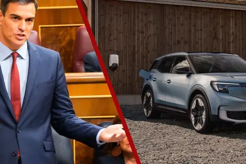 Pedro Sánchez en el Congreso, mientras un coche eléctrico espera su turno en la lista de espera del plan moves iii.
