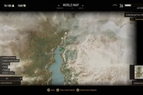 Mapa świata Wiedźmin 3. Widoczna jest lokacja Ruined Watchtower i jezioro. Na dole menu wyboru celu podróży, gdzie można wybrać Kaer Morhen.