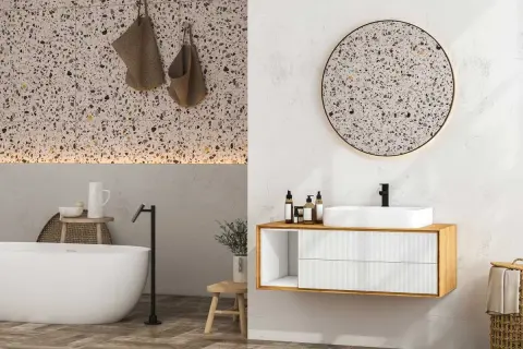 Élégante salle de bain terrazzo avec baignoire, lavabo moderne et miroir rond.