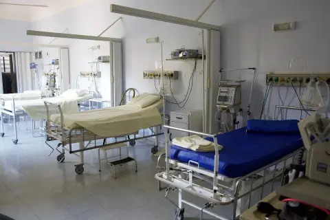 Sala szpitalna z kilkoma łóżkami i aparaturą medyczną. Procedura zgonu w szpitalu to trudny moment.