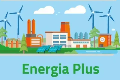 Ilustracja przedstawia nowoczesną fabrykę z turbinami wiatrowymi i panelami słonecznymi, symbolizującą program Energia Plus i ekologiczne rozwiązania.
