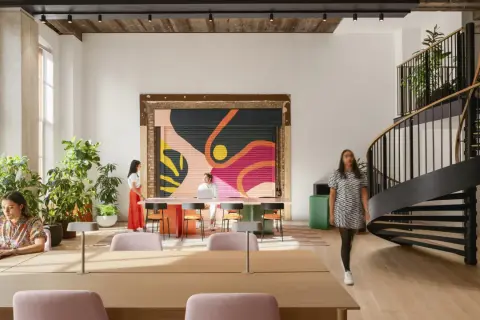 Vibrant mural and spiral staircase showcase current design trends in this modern workspace.