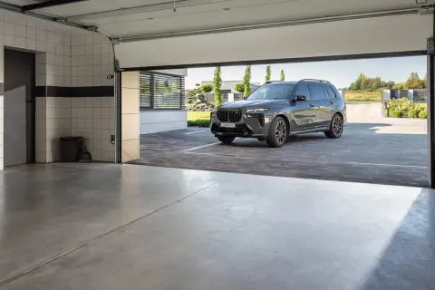 Nowoczesna posadzka w garażu, na której stoi luksusowy SUV.