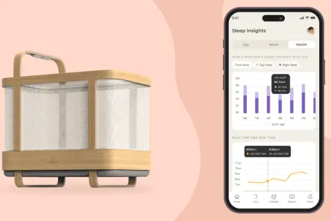 A modern 4 in 1 crib with a phone displaying sleep insights, showing a baby's sleep patterns over time.