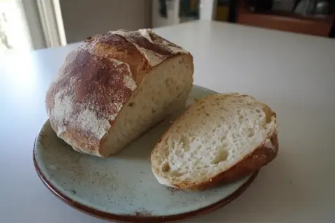 Nybakad ciabatta, perfekt för ditt nästa ciabatta recept. En bit är uppskuren och visar det luftiga inkråmet.