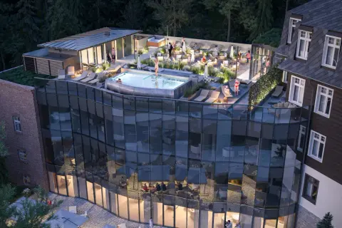 Nowoczesny taras z basenem i leżakami przy hotelu Sanssouci Karpacz. Goście relaksują się w otoczeniu zieleni.