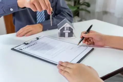 Firma del contratto di compravendita immobiliare con consegna delle chiavi. La procura generale notarile è un atto fondamentale.