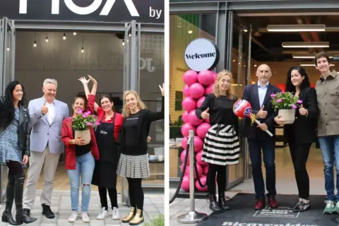 Inauguración de tienda en marketches torre outlet. Gente sonriente celebra la apertura con globos rosas y plantas.