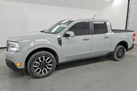 Szary Ford Maverick, kompaktowy pickup, stoi w garażu. Jego linia nadwozia jest nowoczesna, a przednie światła LED nadają mu charakterystyczny wygląd.