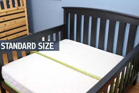 A standard size crib mattress fits perfectly in this toddler bed, showing it does a crib mattress fit a toddler bed.