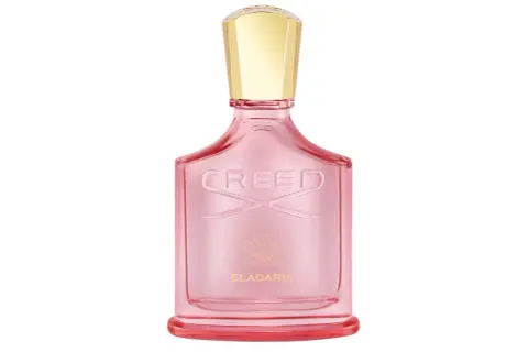 Różowa butelka perfum Creed Eladaria ze złotą nakrętką.
