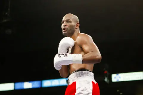 Bernard Hopkins training in the ring, focused and ready. His white gloves are a blur of motion as he prepares for his next fight.