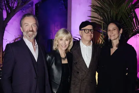Four individuals pose at an event for the Serpentine Americas Foundation.
