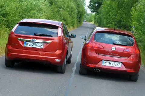 Dwa czerwone samochody jadące obok siebie. Ford Focus i Seat Leon. Czy to wyprzedzanie a wymijanie?