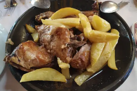 Cordero asado con patatas fritas, un plato típico del rancho el portachuelo.