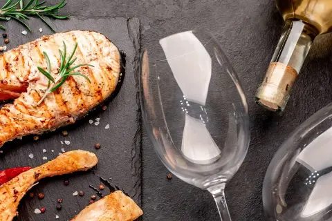 Gegrillter Lachs mit Rosmarin und Pfefferkörnern, bereit für die perfekte Weinbegleitung. Welcher Wein zu Lachs passt, fragst du dich?