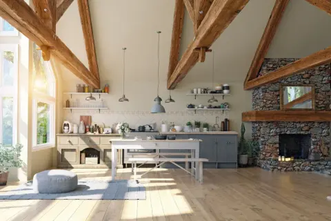 Jasna kuchnia w stylu modern farmhouse z kamiennym kominkiem, drewnianymi belkami i dużymi oknami.