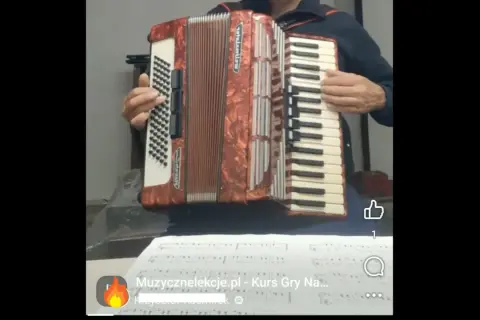 Akordeonista grający najpiękniejsze melodie świata. Nuty na stole.