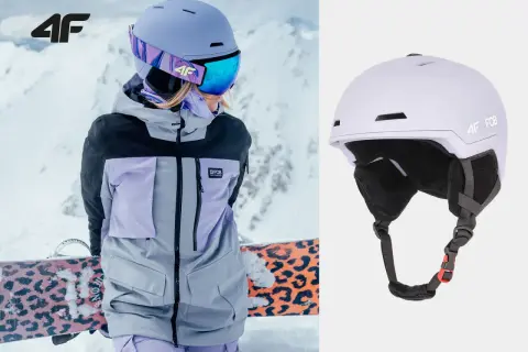 Męski kask narciarski 4F w kolorze liliowym, idealny na stok. Widoczny na zdjęciu z narciarką w kurtce 4F.