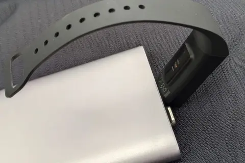 Smartband podłączony do powerbanka, pokazujący, jak ładować smartwatch bez ładowarki.