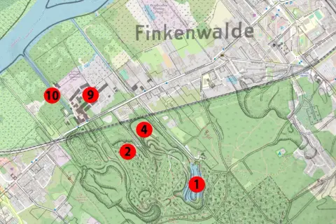 Mapa Finkenwalde z zaznaczonymi punktami. Wzgórza, parki i budynki, a pośrodku malownicze szmaragdowe oczko wodne.
