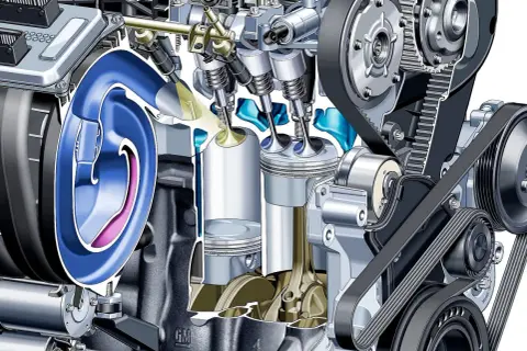Przekrój silnika z widocznymi tłokami, zaworami i układem rozrządu. Ilustracja pokazuje mechanizm, który może zapobiegać nieprawidłowemu spalaniu stukowemu.