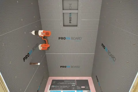 Drill in hand, ready to install concrete board for a shower. This image shows the process of how to install concrete board, with the PROVA BOARD brand visible.
