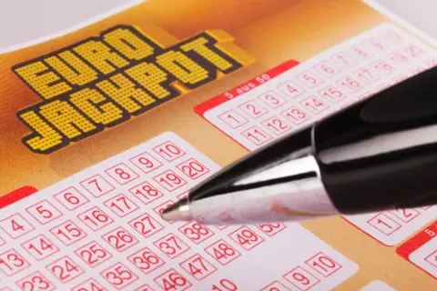 Kupon Eurojackpot z polami do zaznaczenia liczb i długopisem.