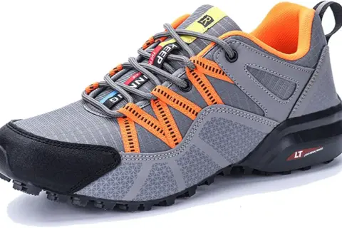 Scarpe da trekking grigie con dettagli arancioni. Il loro significato è comfort e stabilità per ogni avventura.