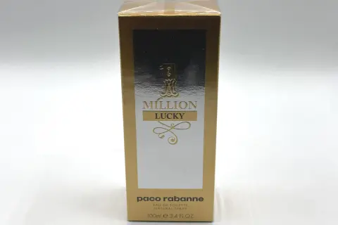 Złote opakowanie Paco Rabanne 1 Million Lucky 100ml z napisem "MILLION LUCKY" i ozdobnymi elementami.